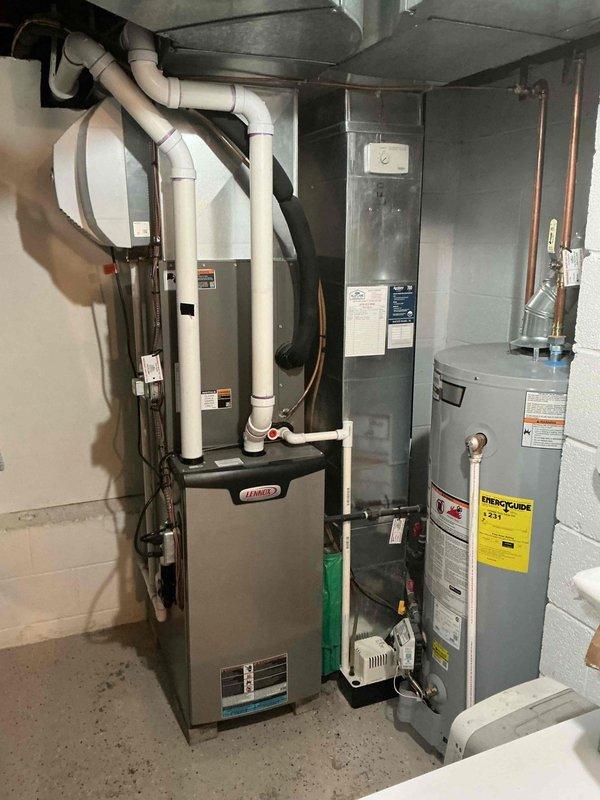 Completed routine cooling maintenance on a 2-year-old Lennox HVAC system. Inspected and verified proper operation of outdoor disconnect and fuse assembly, confirmed electrical connections secure with TR25R time-delay fuses in good condition. Evaluated indoor air handler and refrigerant line connections, documented equipment condition with all components functioning within normal parameters.