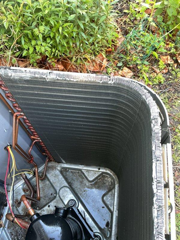 Completed preventive maintenance tune-up on 8-year-old outdoor air conditioning unit. Performed comprehensive system inspection, replaced air filter, and evaluated condenser coil condition. Noted significant deterioration and fin damage along the top edge of condenser coil, which may impact heat transfer efficiency and system performance over time.