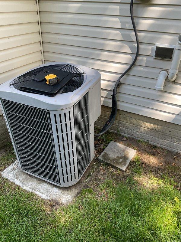 Completed comprehensive AC replacement estimate for residential property. Evaluated existing indoor HVAC system located in basement utility area, including Carrier furnace, Lennox air handler, metal ductwork configuration, and associated white PVC ventilation piping. Assessed outdoor Carrier condenser unit positioned on concrete pad adjacent to home exterior with existing electrical conduit routing through vinyl siding. Photographed and documented current system components, installation layout, ductwork connections, and equipment specifications to provide accurate replacement proposal for complete air conditioning system upgrade.