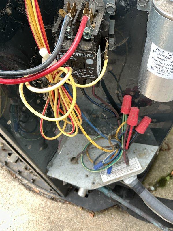 Completed annual cooling maintenance on a 5-year-old residential air conditioning system. Removed top panel to access condenser coil assembly, which exhibited significant accumulation of dust, lint, and debris throughout the barrel-style coil fins and grooves. Thoroughly cleaned condenser coil to restore proper airflow and heat transfer efficiency. Inspected electrical components including contactor, capacitor, and all wire connections, verifying secure terminations and proper operation. System tested and confirmed operational following maintenance procedures.