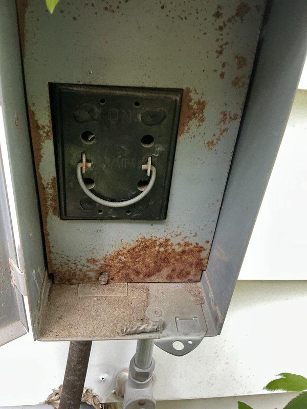 Performed routine maintenance on 6-year-old air conditioning system. Inspected outdoor disconnect box, which showed significant rust staining and corrosion on exterior surfaces and accumulated oxidation debris. Unit remains operational and accessible for future service needs.