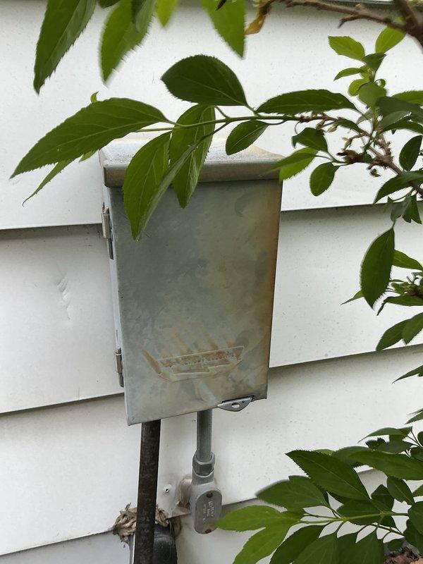 Performed routine maintenance on 6-year-old air conditioning system. Inspected outdoor disconnect box, which showed significant rust staining and corrosion on exterior surfaces and accumulated oxidation debris. Unit remains operational and accessible for future service needs.