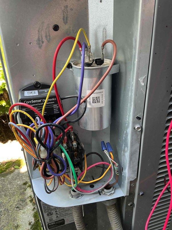 Responded to service call for furnace and exterior unit making noises. Upon arrival, inspected outdoor AC unit and found 2016 Goodman CDMQV-035RPA condenser with operational concerns. Opened access panel and performed electrical diagnostics on system components. Inspected capacitor (CAP050350440CS) for proper operation and checked all electrical connections including wiring to compressor and fan motor. Evaluated CoreSense Diagnostics module and verified wire connections including power, control, and sensor leads. Checked contactor, relay switches, and mounting hardware for secure installation. Documented equipment condition with photos showing capacitor specifications, wiring configuration, and diagnostic components. System evaluated for noise sources related to mechanical and electrical components. Customer advised of findings and potential plumbing leak requiring separate evaluation by qualified plumber, as this falls outside HVAC scope of work.
