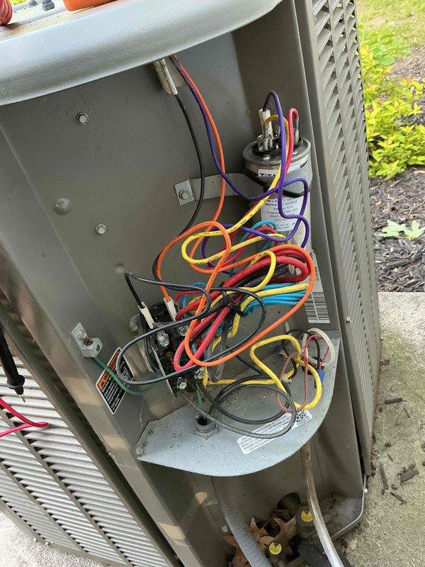 Completed routine maintenance on 15-year-old residential cooling system, including inspection of electrical components, capacitor testing, and verification of proper operation. Unit exterior and internal wiring connections were examined and found to be in functional condition, with all safety checks performed according to MVP Cooling Visit protocol.
