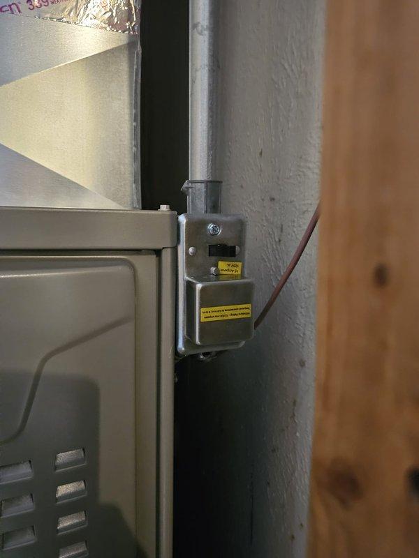 Completed installation of 45,000 BTU 80% efficiency furnace in utility area with proper mounting and leveling. Unit was secured to concrete block wall with appropriate brackets and safety labeling, all electrical connections were terminated, and system was verified level for optimal operation. Supply duct sizing and ceiling register placement near furnace were assessed for proper airflow distribution.