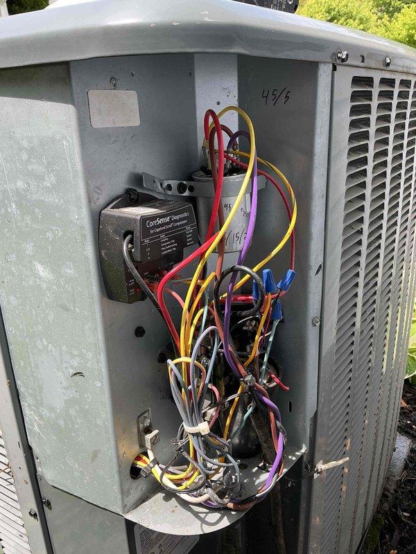 Completed maintenance visit on 9-year-old air conditioning system. Performed inspection of outdoor unit, accessing electrical compartment to verify proper operation of ConServe control module and associated wiring connections. Examined capacitor labeled CAP05045044OCT dated 2018, confirming component integrity and proper electrical connections. All components functioning within normal parameters at time of inspection.