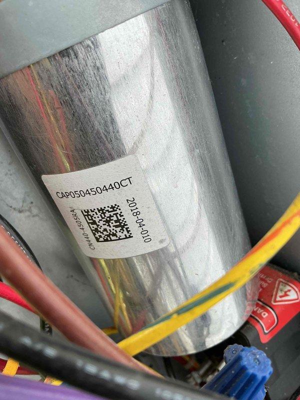 Completed maintenance visit on 9-year-old air conditioning system. Performed inspection of outdoor unit, accessing electrical compartment to verify proper operation of ConServe control module and associated wiring connections. Examined capacitor labeled CAP05045044OCT dated 2018, confirming component integrity and proper electrical connections. All components functioning within normal parameters at time of inspection.