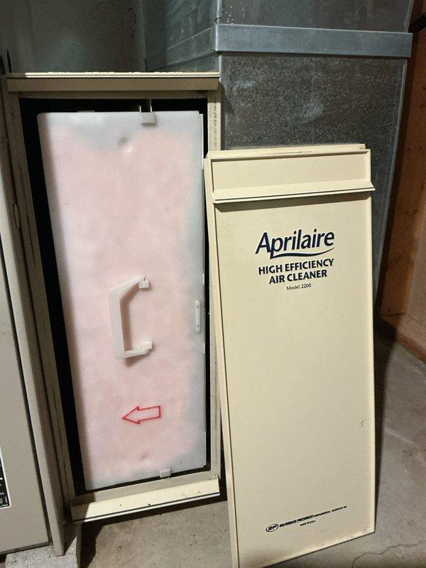 Responded to no cooling call on 20-year-old residential air conditioning system. Upon arrival, confirmed unit would not power on and performed diagnostic inspection of both indoor and outdoor components. Inspected Lennox furnace and air handler assembly in basement, checked electrical connections, verified thermostat communication, and examined recent service history indicating previous part replacement. Evaluated system age and operational status, documented equipment condition with photos of furnace, ductwork, and Aprilaire air cleaner installation. Provided customer with findings and recommendations for system repair or replacement given the advanced age of the equipment.