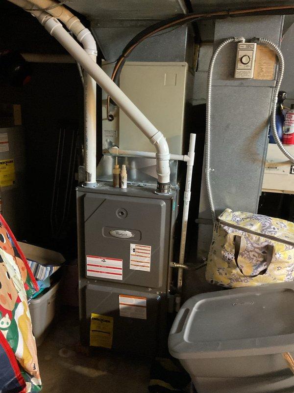 Conducted comprehensive AC system estimate for complete HVAC replacement at residential property. Assessed existing Coleman outdoor condensing unit and indoor furnace system, documenting current equipment configuration including ductwork, PVC condensate drainage, copper refrigerant lines, and electrical disconnect. Photographed indoor mechanical room setup showing furnace with connected air handling components and outdoor condenser placement on concrete pad against home exterior. Evaluated system accessibility, electrical service requirements, and existing installation conditions to provide accurate replacement recommendations and specifications for new equipment installation.