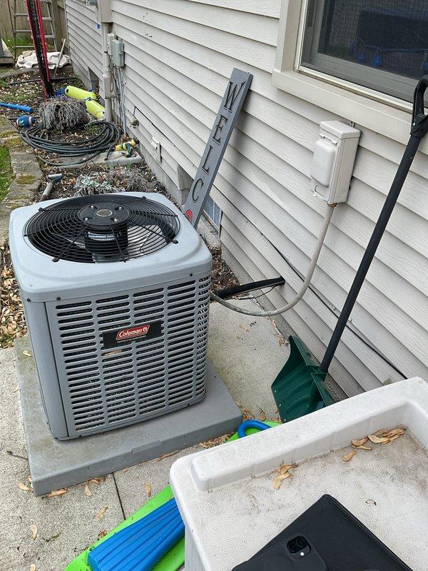 Conducted comprehensive AC system estimate for complete HVAC replacement at residential property. Assessed existing Coleman outdoor condensing unit and indoor furnace system, documenting current equipment configuration including ductwork, PVC condensate drainage, copper refrigerant lines, and electrical disconnect. Photographed indoor mechanical room setup showing furnace with connected air handling components and outdoor condenser placement on concrete pad against home exterior. Evaluated system accessibility, electrical service requirements, and existing installation conditions to provide accurate replacement recommendations and specifications for new equipment installation.
