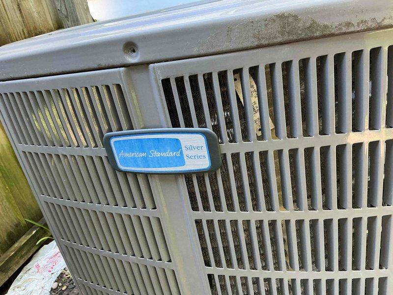 # HVAC Service Report

Responded to no cooling complaint on American Standard Silver Series air conditioning system approximately 3-5 years old. Upon arrival, performed comprehensive system diagnostic including visual inspection of both indoor furnace/air handler unit and outdoor condensing unit. Outdoor unit showed significant dirt and debris accumulation on condenser coils and interior components, with vegetation matter visible through ventilation grilles. Indoor air handler and ductwork connections inspected in basement mechanical room, with air filter condition evaluated. Completed standard diagnostic procedures to identify cause of cooling failure and provided customer with findings and repair recommendations.