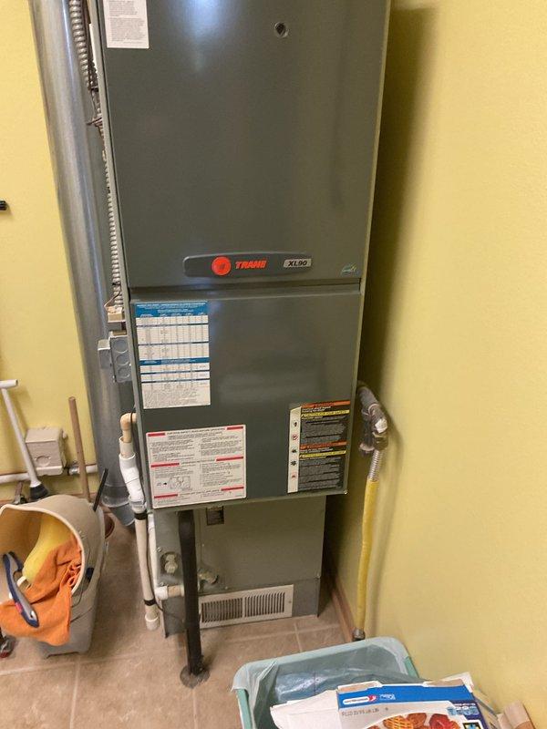 Completed comprehensive HVAC system evaluation for equipment replacement in residential utility closet. Assessed existing Trane XL80i air handler unit, associated venting infrastructure including dual white PVC exhaust pipes with proper coupling bands, flexible metal conduit, and auxiliary components including wall-mounted humidifier and thermostat control. Documented current system configuration, mechanical room layout, and installation conditions to provide accurate replacement specifications and equipment recommendations for new HVAC system installation.