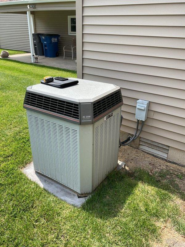 Conducted on-site evaluation for complete air conditioning system replacement. Assessed existing Trane XV 1200 outdoor condensing unit located on concrete pad with proper clearance from structure, noting electrical disconnect and refrigerant line penetrations. Evaluated basement mechanical room infrastructure including existing PVC condensate drain system and mounting platform. Provided comprehensive estimate for new equipment installation including outdoor unit replacement, indoor air handler considerations, and necessary modifications to existing piping and electrical connections.