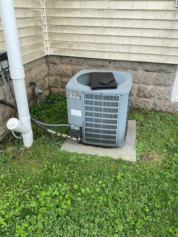 Conducted comprehensive assessment of existing HVAC system at older residential property for complete replacement estimate. Inspected and documented basement-mounted furnace unit with access panels opened to evaluate internal components, control boards, wiring configurations, and mechanical condition. Evaluated outdoor condensing unit positioned on concrete pad against foundation, noting equipment age, condition, and operational status. Captured detailed photographs of both indoor and outdoor equipment, ductwork connections, and installation environment to support replacement proposal and system design recommendations.
