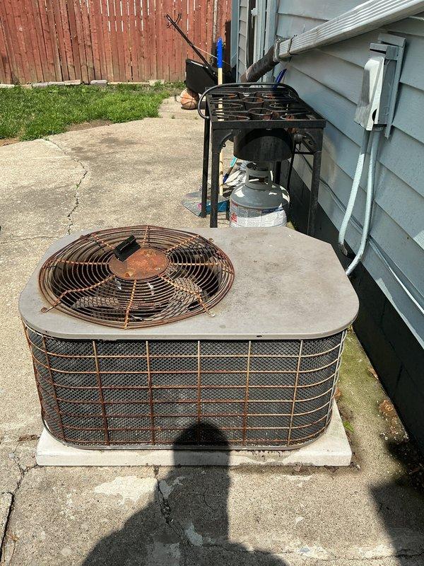 Responded to no-cooling complaint on residential split system air conditioning unit. Upon arrival, found outdoor condenser unit with significant rust deterioration on fan grille and exterior housing, indicating advanced age and weather exposure. Performed diagnostic evaluation of both outdoor condensing unit and indoor air handler/furnace assembly. Inspected ductwork, refrigerant lines, electrical connections, and condensate drainage system. System evaluated for proper operation, refrigerant levels, and component functionality to identify cause of cooling failure and restore air conditioning service to residence.