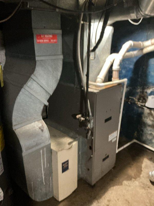 Responded to no-cooling complaint on residential split system air conditioning unit. Upon arrival, found outdoor condenser unit with significant rust deterioration on fan grille and exterior housing, indicating advanced age and weather exposure. Performed diagnostic evaluation of both outdoor condensing unit and indoor air handler/furnace assembly. Inspected ductwork, refrigerant lines, electrical connections, and condensate drainage system. System evaluated for proper operation, refrigerant levels, and component functionality to identify cause of cooling failure and restore air conditioning service to residence.