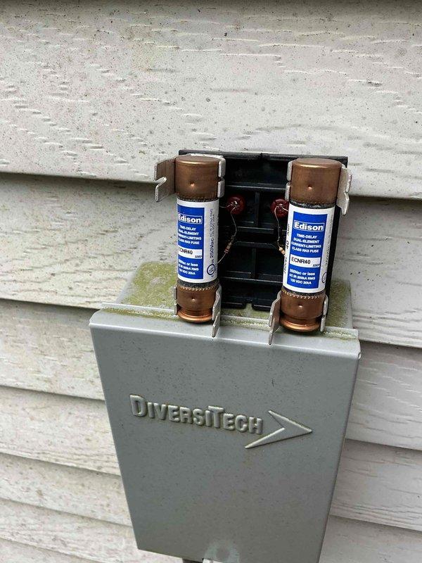 Completed scheduled AC maintenance visit including inspection of outdoor disconnect box with DiversiTech enclosure and Edison fuses, and indoor furnace unit with associated condensate drain lines and refrigerant piping. All electrical components, safety disconnects, and system connections were inspected and found to be in proper working order for continued cooling season operation.