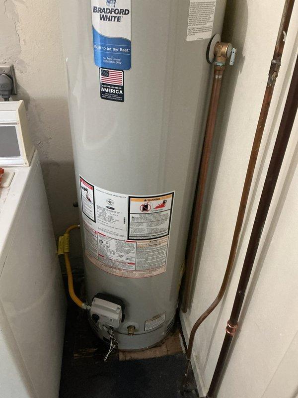 Responded to callback for inspection correction on recently installed Bradford White water heater. Inspector required tank rotation to provide proper clearance for future service and maintenance access. Repositioned water heater to meet code compliance while maintaining all existing plumbing connections, gas line routing, and pressure relief valve placement. Verified all connections remained secure and leak-free after rotation, ensuring unit meets required clearance specifications for service accessibility.