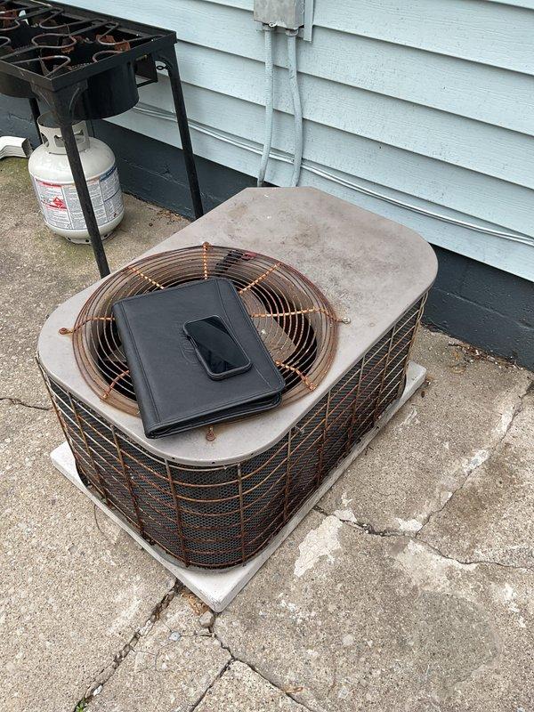 Conducted comprehensive assessment of existing HVAC system for replacement estimate. Evaluated aging furnace unit in basement mechanical room, noting current configuration with PVC condensate and exhaust piping, proximity to water heater, and integration with existing ductwork infrastructure. Documented condition of outdoor air conditioning unit showing significant weathering, accumulated debris on top panel and fan guard, and deteriorated concrete pad with multiple cracks requiring attention during replacement installation.