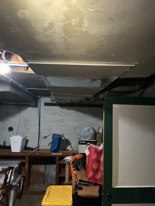 Responded to service call for air conditioning system not blowing cold air at rental property. Accessed property per landlord instructions and performed diagnostic inspection of Luxaire HVAC system located in basement utility area. Documented existing conditions including unit configuration, ductwork, and surrounding mechanical room environment during assessment.