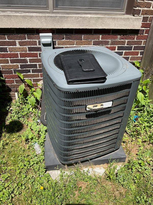 Completed comprehensive estimate for full HVAC system replacement including outdoor condensing unit and indoor furnace. Assessed existing dark gray cylindrical condenser positioned against brick exterior wall and basement-installed furnace with existing ductwork configuration. Provided customer with equipment options and replacement specifications for complete system upgrade.