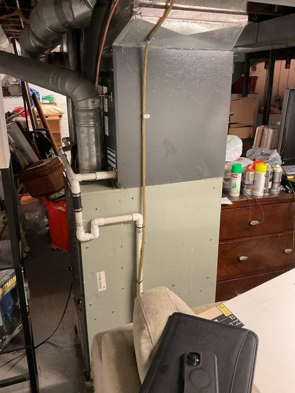 Completed comprehensive estimate for full HVAC system replacement including outdoor condensing unit and indoor furnace. Assessed existing dark gray cylindrical condenser positioned against brick exterior wall and basement-installed furnace with existing ductwork configuration. Provided customer with equipment options and replacement specifications for complete system upgrade.