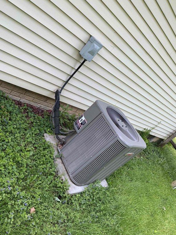 Completed comprehensive tune-up maintenance on residential HVAC system including outdoor condensing unit and indoor equipment. Performed standard inspection procedures, verified proper operation of all components, and documented system condition with photographs showing AC condenser unit, water heater, and Aprilaire humidifier in basement mechanical room.