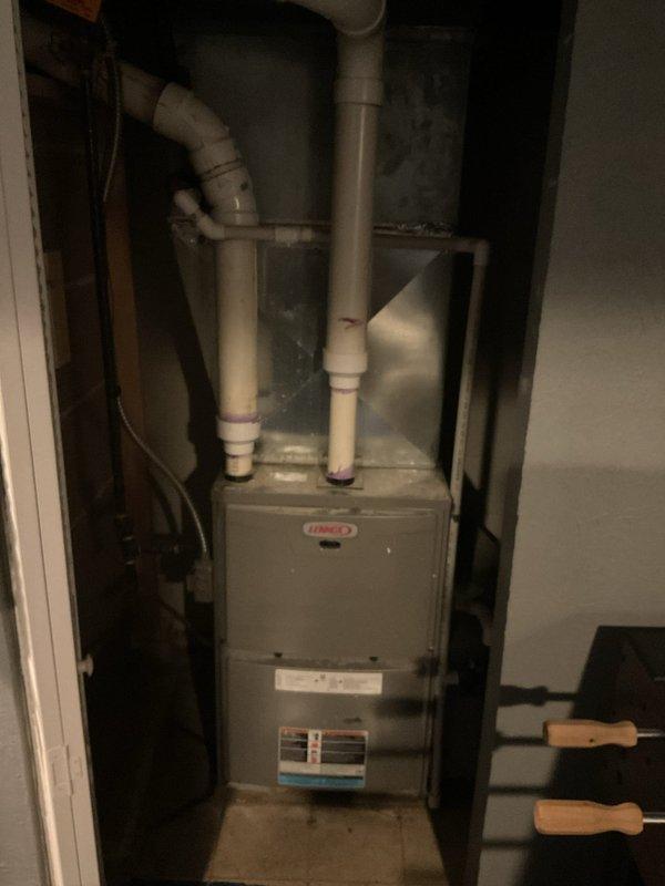 Conducted comprehensive AC replacement estimate for residential property. Evaluated existing outdoor Lennox condenser unit showing significant weathering, discoloration, and age-related deterioration on concrete pad with algae growth, along with indoor Lennox furnace system with proper PVC venting configuration. Documented current equipment conditions, measurements, and installation specifications to provide replacement system recommendations and pricing options for complete HVAC system upgrade.