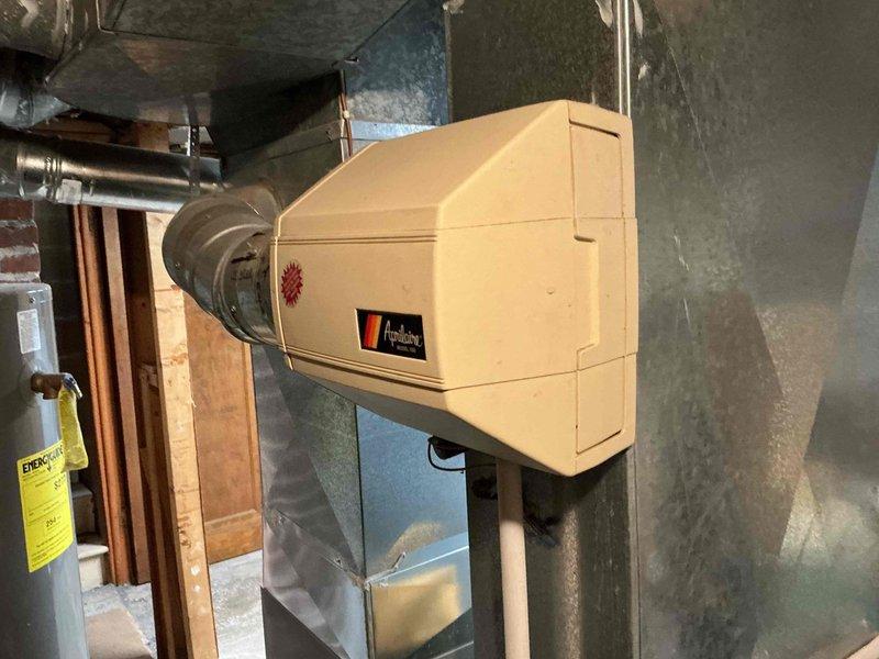 Completed MVP air conditioning tune-up on 10-year-old outdoor unit. Appointment was rescheduled as customer had another A/C installation in progress at a different property. System inspection included evaluation of indoor air handler components and Aprilaire humidifier attachment with visible dust accumulation typical of basement installations.