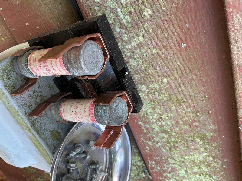 Completed scheduled MVP cooling maintenance visit. Inspected outdoor condensing unit, electrical disconnect box, and refrigerant line set. Unit components showing age-related weathering but operational. Documented existing conditions including moss accumulation on surrounding deck structure and exterior weathering of electrical components. Fuse block and disconnect box inspected and confirmed secure. System functional at time of service.