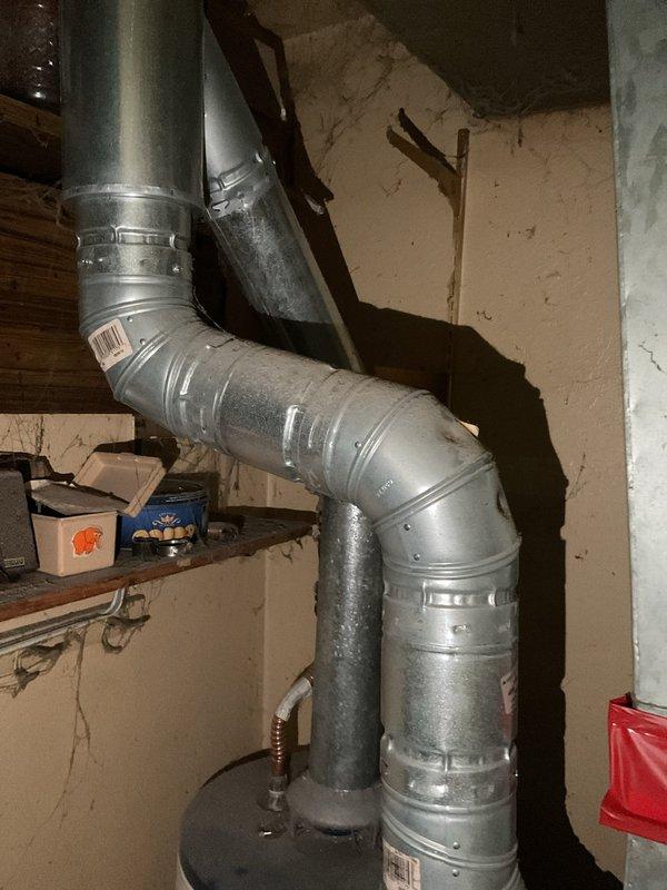 Conducted on-site evaluation for water heater replacement in residential mechanical room. Assessed existing Envirotemp water heater unit with connected gas lines, shut-off valves, and water supply piping. Documented current installation configuration including proximity to furnace unit and existing electrical connections. Evaluated potential electrical upgrades required for new water heater installation, examining current wiring capacity and code compliance requirements. Photographed mechanical room layout, ductwork clearances, and utility connections to develop comprehensive replacement proposal.
