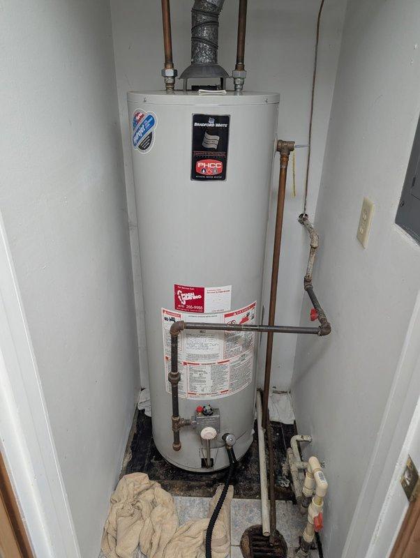 Responded to no water emergency call for landlord/tenant property. Assessed existing water heater system and provided quote for replacement of 40-gallon Bradford White natural gas water heater (Model M140T6FN12). Unit was installed in narrow utility closet with proper venting and copper supply lines with dielectric unions. Documented existing installation including energy guide labels, manufacturer specifications, and clearance requirements. Coordinated directly with landlord for approval and payment authorization prior to proceeding with replacement work.