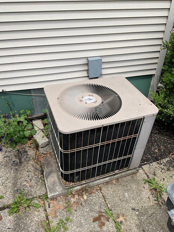 Completed comprehensive assessment of existing HVAC system for full replacement estimate. Evaluated outdoor condenser unit showing signs of age and weathering, positioned on deteriorated concrete pad with visible cracking and vegetation growth. Unit displayed functional operation but exhibited wear consistent with extended service life. Documented electrical disconnect and reviewed exterior installation conditions including clearances and mounting surface integrity.

Inspected indoor furnace system with access panel removed to assess internal components and compatibility requirements for new equipment. Examined gas burner assembly, control wiring, gas valve connections, and pilot light operation. Verified existing ductwork connections, return air configuration, and available installation space for replacement equipment. Measured clearances and documented current system specifications to ensure proper sizing and compatibility of proposed replacement unit. Photographed both indoor and ou