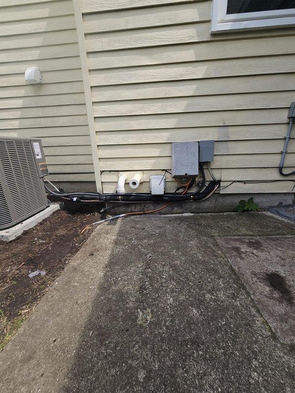 Completed installation of 2.5 ton single-stage AC package unit with slim duct air handler. Relocated condenser unit from concrete to new pad in flower bed, maintaining required 3-foot clearance from electrical meter per code. Installed new 3/4-inch line set spanning 205 feet connecting outdoor condenser to indoor air handler. Ran new electrical whip and installed disconnect box at exterior unit location. Mounted programmable thermostat for system control. All refrigerant lines properly insulated and secured, condensate drainage installed with appropriate traps, and electrical connections completed to code specifications. System tested and operational upon completion.