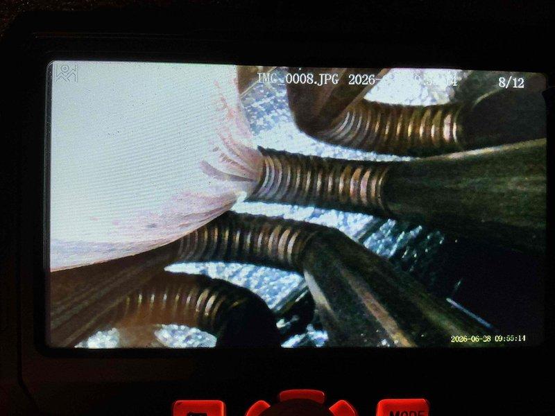Responded to service call for 5-year-old air conditioning system experiencing cooling issues. Upon inspection, discovered significant frost and ice buildup on evaporator coils and refrigerant lines, indicating restricted airflow or possible refrigerant charge imbalance. Documented conditions with photographic evidence showing crystalline ice accumulation on copper refrigerant lines and coil surfaces. Assessed system components including corrugated flexible ductwork and insulation in attic installation area. Identified freezing condition as primary concern requiring immediate attention to restore proper cooling operation and prevent compressor damage.