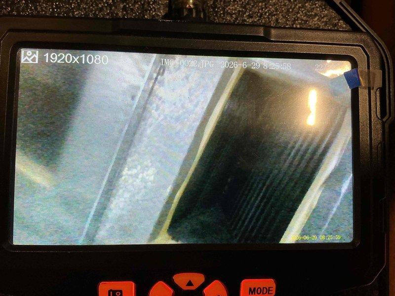 Completed comprehensive maintenance tune-up on 30-year-old outdoor air conditioning unit. Performed detailed inspection of evaporator coil and internal ductwork components using borescope camera, revealing accumulated dirt and debris on coil fins. Unit operational following standard preventive maintenance procedures.
