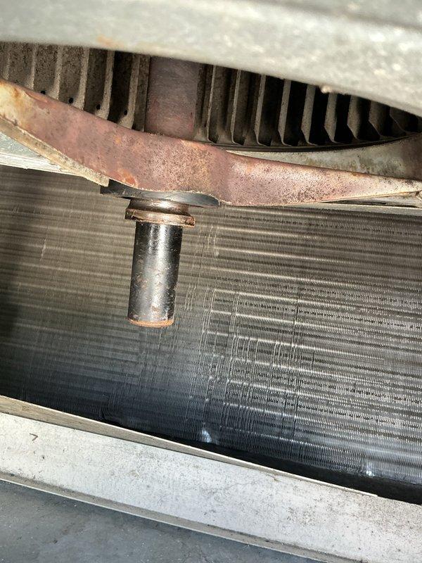 Responded to service call for 24-year-old rooftop air conditioning unit with reported blower motor shaft mounting bracket loose and wobbling. Upon inspection, accessed blower assembly and confirmed mounting bracket had come loose, causing excessive vibration and movement of the motor shaft. Secured and tightened mounting hardware to stabilize blower motor assembly, eliminating wobble. Verified proper operation of blower wheel and motor shaft alignment. Unit tested and returned to normal operation with no further vibration detected.