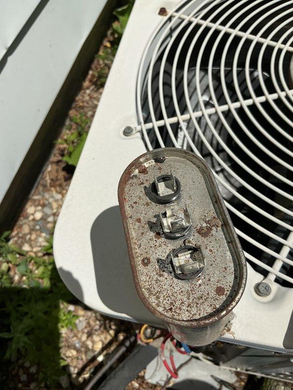 Performed comprehensive tune-up on 20+ year old outdoor air conditioning system. Unit inspection revealed aging equipment with heavily corroded electrical disconnect box showing significant rust and weathering, though system remains operational. Completed standard maintenance procedures including cleaning condenser coils, checking refrigerant levels, testing electrical connections, inspecting fan motor and blade assembly, and verifying proper system operation.