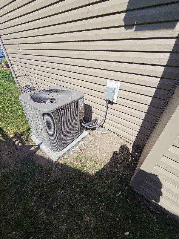 Completed full HVAC system replacement including installation of a 2.5 ton, 15.5 SEER air conditioning system with single-stage condenser unit positioned on new concrete equipment pad with electrical disconnect box, connected via new 3/4" x 25' refrigerant line set. Installed 70,000 BTU, 96% AFUE downflow gas furnace with cased coil and lift box configuration, integrated with humidifier system and proper condensate drainage using PVC piping. Programmed and installed new thermostat to control complete heating and cooling system, verified all electrical connections, tested system operation, and confirmed proper airflow and refrigerant charge levels.