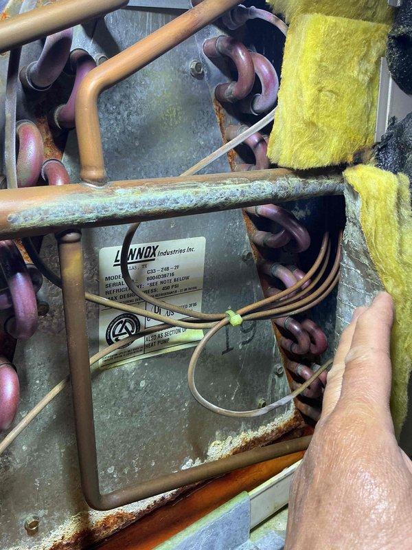 Completed MVP cooling maintenance visit on 21-year-old Lennox air conditioning system. Performed comprehensive inspection of outdoor condensing unit, including evaluation of copper refrigerant lines showing age-appropriate oxidation and patina development, heat exchanger coil assembly with corrugated aluminum fins, and associated piping connections. Documented equipment condition through photographic records, noting operational wear patterns, surface oxidation on metal housing, and existing thermal insulation integrity. All maintenance procedures completed per manufacturer specifications for aging residential cooling equipment.
