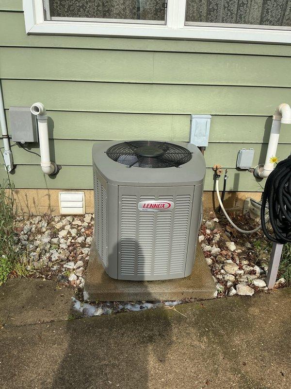 Performed routine maintenance on Lennox air conditioning system. Inspected outdoor condenser unit, verified proper operation of fan and compressor, and examined refrigerant line connections. Checked condensate drain lines and PVC piping for proper drainage and secure fittings. Unit found operating within normal parameters with no immediate service needs identified.