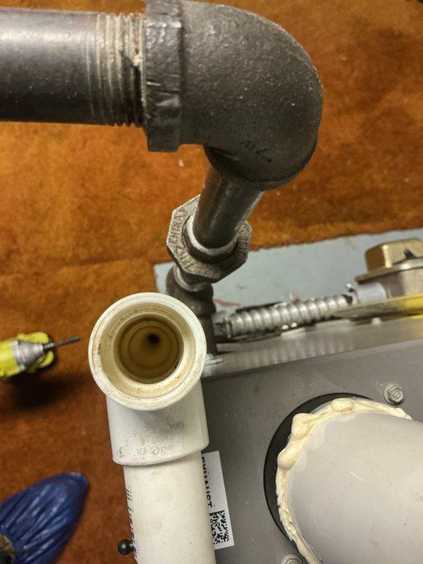 Performed routine maintenance on Lennox air conditioning system. Inspected outdoor condenser unit, verified proper operation of fan and compressor, and examined refrigerant line connections. Checked condensate drain lines and PVC piping for proper drainage and secure fittings. Unit found operating within normal parameters with no immediate service needs identified.