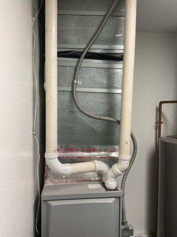 Conducted comprehensive evaluation of existing HVAC system for air conditioning replacement estimate. Assessed current Concord furnace installation and associated mechanical components including air handler unit, copper refrigerant lines, PVC condensate drainage system, and flexible electrical conduit. Documented equipment configuration in interior mechanical closet, noting standard residential installation with existing infrastructure suitable for new AC system integration. Photographed current setup to provide accurate replacement specifications and facilitate proper equipment sizing for upcoming air conditioning unit installation.