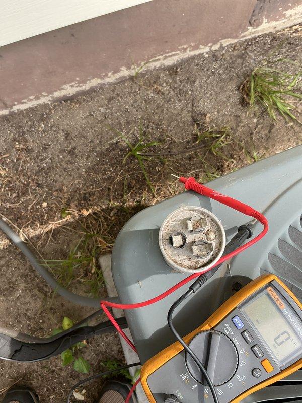 Completed scheduled air conditioning maintenance on 13-year-old system. Performed standard cooling season inspection including capacitor testing with multimeter to verify proper electrical function and checked disconnect box fuses for integrity. All components tested within normal operating parameters and system found to be functioning properly for continued cooling operation.