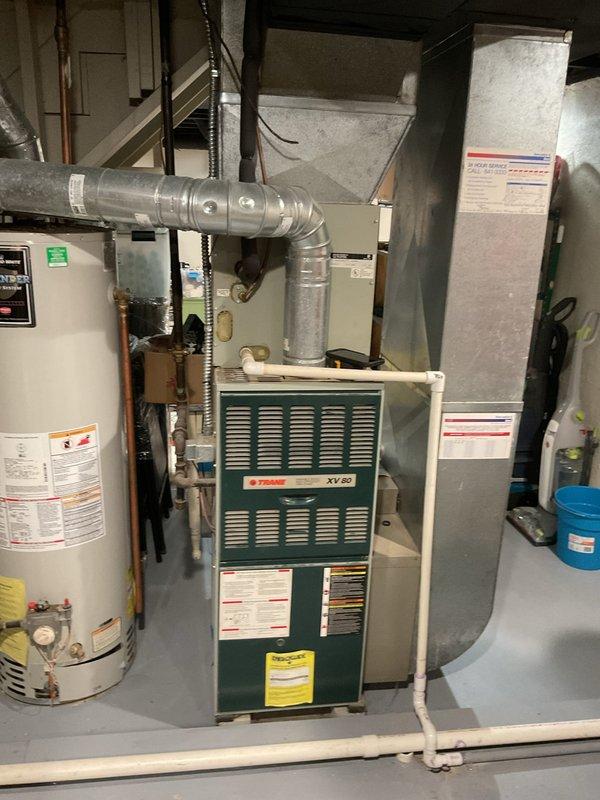 Conducted comprehensive assessment of existing HVAC system for full replacement estimate. Evaluated current Trane XV80 furnace unit and associated air handler equipment located in basement mechanical room. Documented existing ductwork configuration, including metallic supply ducts and flexible aluminum connections routing from equipment. Assessed condition of current system components, support structures, and utility connections including gas lines, electrical service, and condensate drainage. Photographed equipment specifications, model numbers, and existing installation layout to determine proper replacement sizing and configuration requirements. Provided detailed estimate for complete system replacement including new furnace, air handler, ductwork modifications as needed, and all associated installation labor and materials.