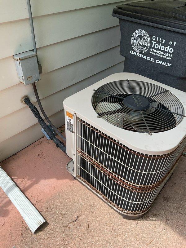 Provided comprehensive estimate for complete HVAC system replacement including outdoor air conditioning condenser unit and indoor furnace system. Assessed existing equipment configuration in basement utility area, documenting current gray metal furnace with vertical PVC venting, air handler with metallic ductwork, and outdoor white cabinet AC unit with top-discharge fan positioned on concrete pad adjacent to residence with electrical disconnect properly installed.