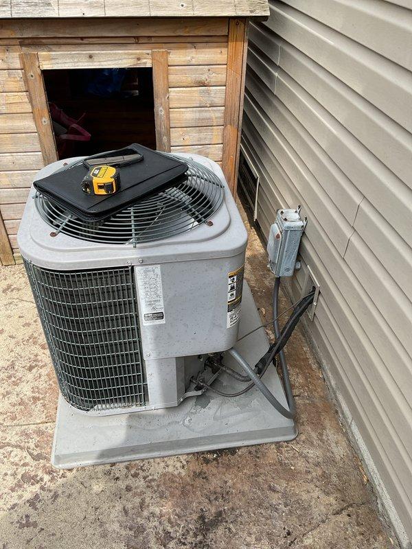 Conducted comprehensive assessment of existing HVAC system for complete replacement estimate. Evaluated indoor air handler unit located in basement utility area, noting aged copper refrigerant lines with oxidation, filter drier component, and PVC condensate drainage system. Inspected outdoor condensing unit positioned on concrete pad with electrical disconnect, documenting current equipment specifications and installation configuration. Photographed both components to provide detailed documentation of existing system condition for replacement proposal.