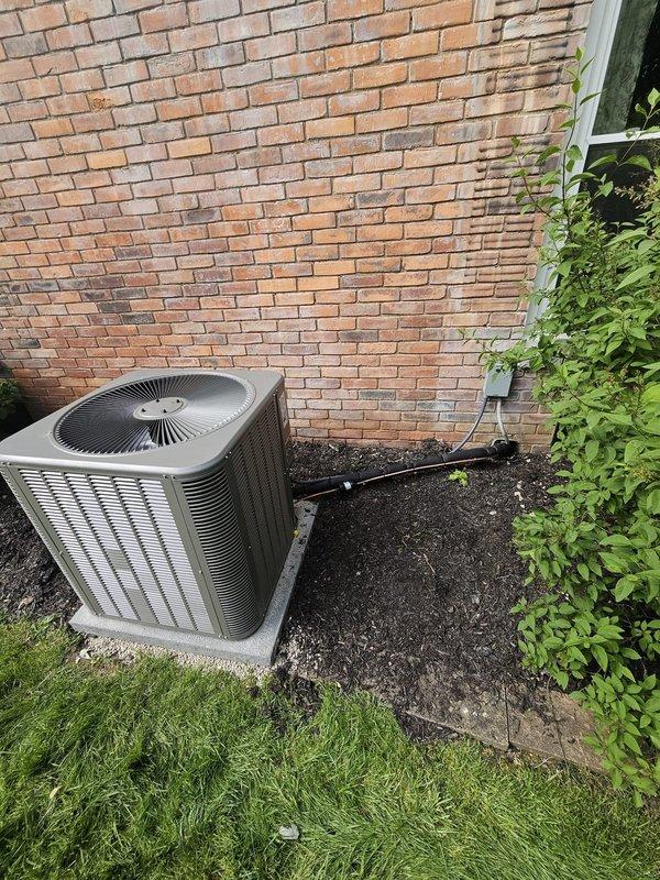 Completed full HVAC system installation including outdoor condensing unit and indoor upflow cased coil package. Installed new 7/8" x 30' refrigerant lineset with proper insulation to connect outdoor and indoor components. Set outdoor unit on new concrete pad positioned against exterior brick wall with proper clearances for airflow and service access. Installed new electrical disconnect box for code-compliant power supply to condensing unit. Mounted and wired WiFi-enabled thermostat for remote system control and monitoring capabilities. Verified all refrigerant connections, tested system operation, and confirmed proper cooling performance upon startup.