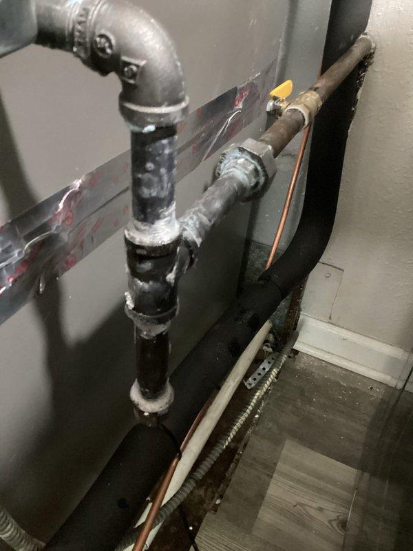 Completed final installation of HVAC system components in mechanical space, including connection of refrigerant lines, ductwork, and associated piping. Verified all pipe connections, shut-off valves, and system integration with existing infrastructure. Documented completed installation with photos showing proper placement of equipment, piping configuration, and mechanical room layout.