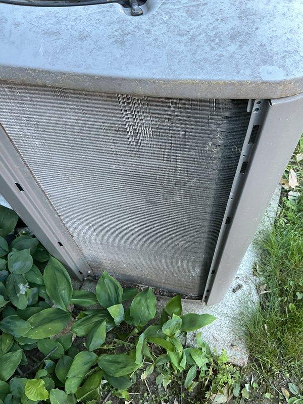 Completed routine cooling maintenance on an 18-year-old air conditioning system. Inspected outdoor condenser unit, verified heat exchanger coils and fins for proper condition, and examined indoor air handler components including insulation integrity. System operational and ready for continued service.